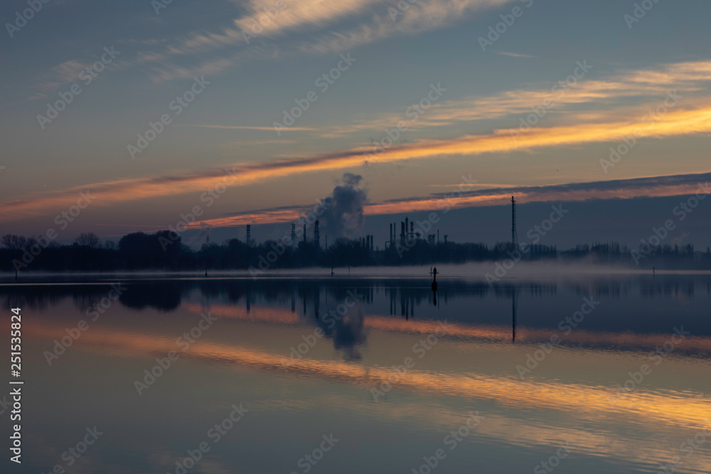 Dawn on a lake with industrial background