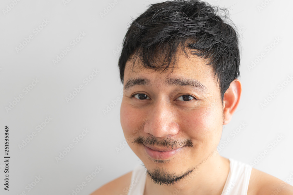 Poor and depressed face of man on grey background. Concept of desperate life. Poor and depressed face of man on grey background. Concept of desperate life.