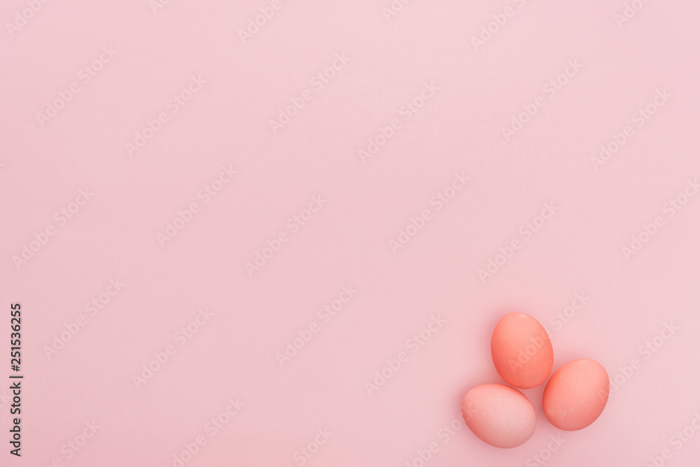 top view of three pastel easter eggs isolated on pink with copy space top view of three pastel easter eggs isolated on pink with copy space