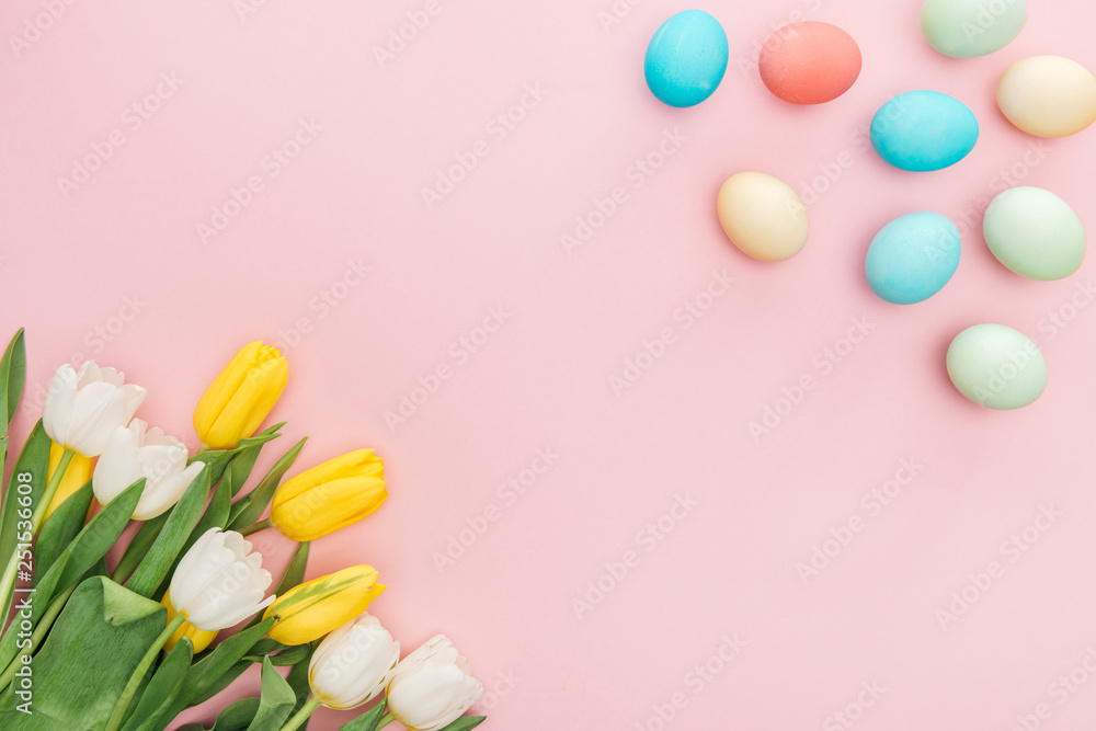 top view of tulip flowers and traditional easter eggs isolated on pink top view of tulip flowers and traditional easter eggs isolated on pink