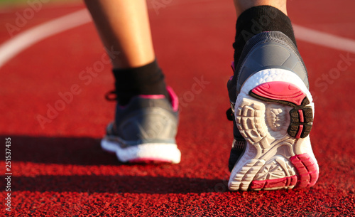 Woman running on athletic track