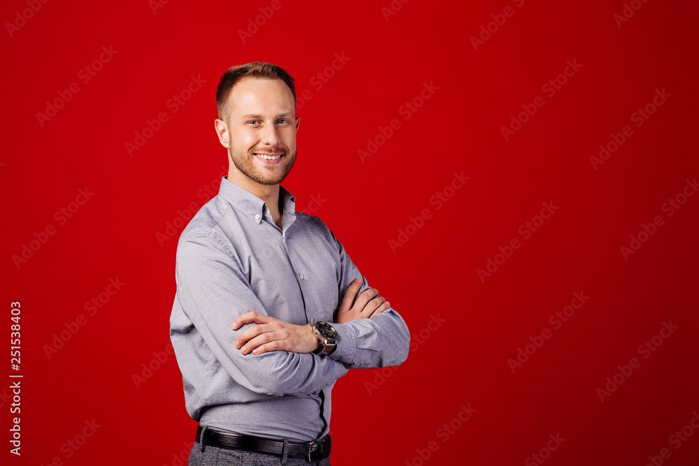 man with crossed arms over red background. people and emotion concept. man with crossed arms over red background. people and emotion concept.