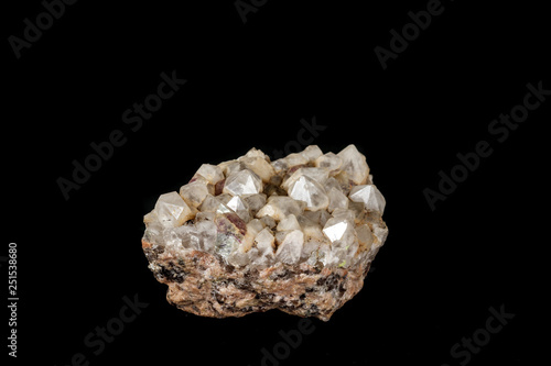 Macro mineral quartz stone with fluorite on granite on a black background