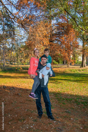Dad with three children in the arms in the park © nedomacki