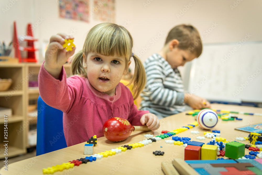 Fototapeta premium Montessori class, kids are playing and learning