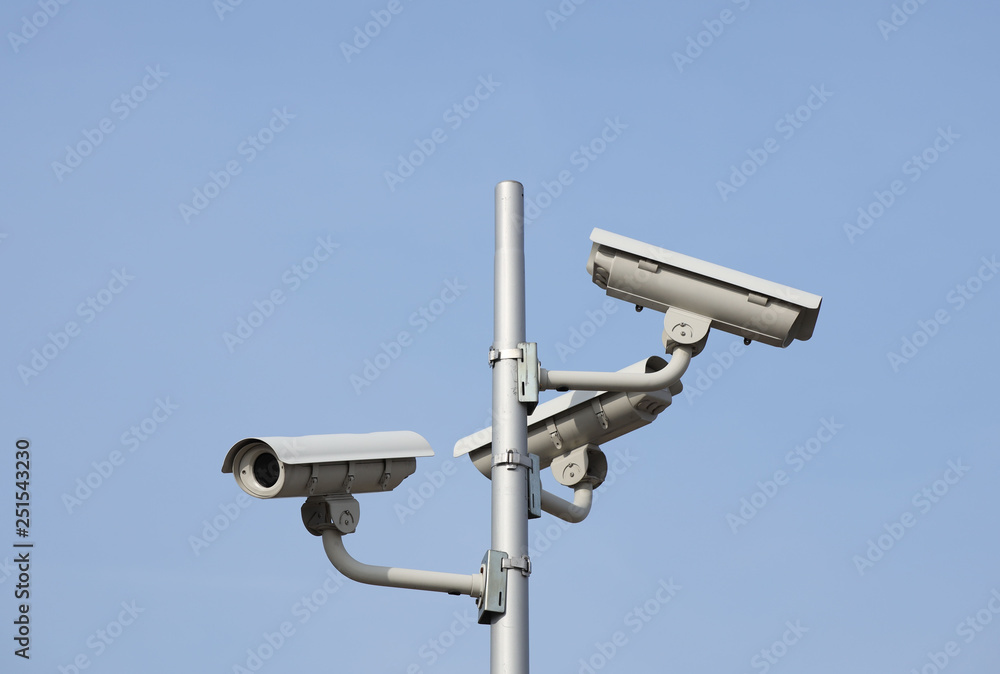 Surveillance system of three cameras located on a pole in the open. Threat to privacy and personal data protection. Security surveillance on the streets of the city and industrial objects Surveillance system of three cameras located on a pole in the open. Threat to privacy and personal data protection. Security surveillance on the streets of the city and industrial objects