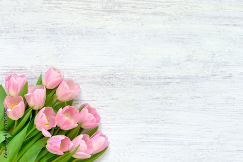 Fototapeta Naklejka Na Ścianę i Meble -  Pink tulips on white background. Top view, copy space. Greeting card.