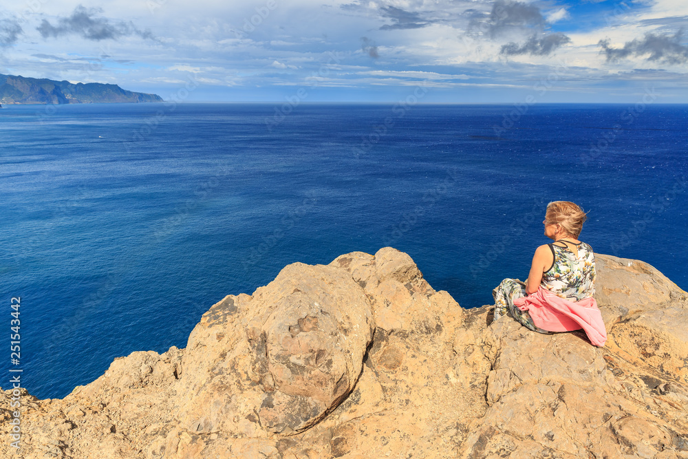 Tourist on the cliffs in the beautiful landscape of the east coast of the island Madeira at Ponta de Sao Lourenco nature reserve