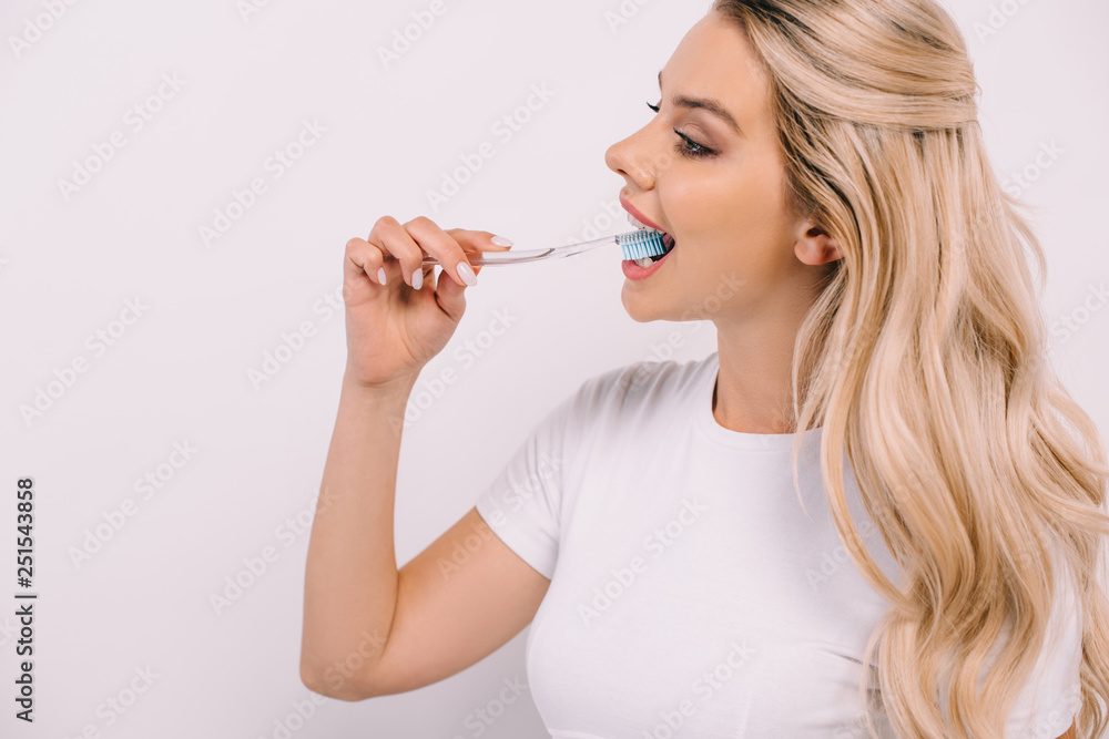 beautiful woman in white t-shirt brushing teeth isolated on white with copy space beautiful woman in white t-shirt brushing teeth isolated on white with copy space