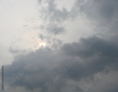 Panorama of the sky, where the southern sun tries to break through the dense wall of stormy clouds.