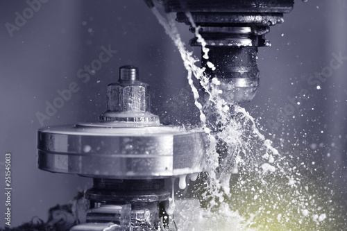 Fotografie Spindle chuck and installed metal part in pocessing on high precision Cnc industrial lathe turning machine