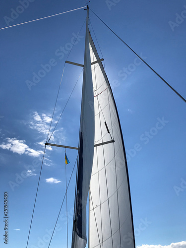 sails sailing yacht in the wind in the blue sky