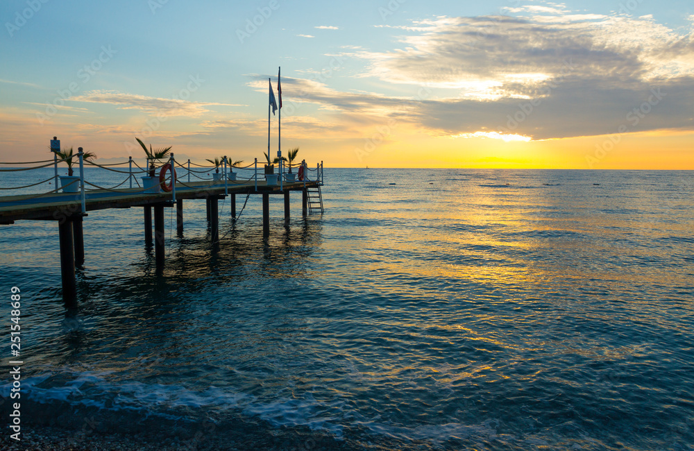 Sunrise on the sea with a pier in Kemer