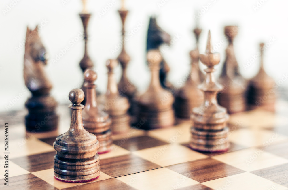 Wooden chess pieces on a chessboard, leadership concept on white background. Wooden chess pieces on a chessboard, leadership concept on white background.