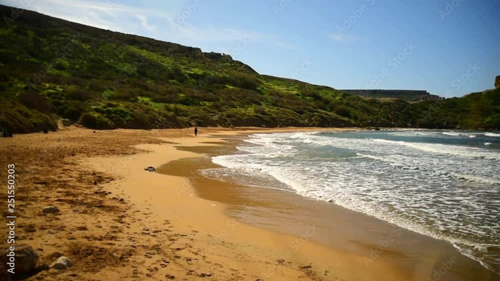 Waves on Riviera beach, Mgarr, Malta. Ghajn Tuffieha Bay with golden sand. Mediterranean sea lagoon landscape. Sea sound Waves on Riviera beach, Mgarr, Malta. Ghajn Tuffieha Bay with golden sand. Mediterranean sea lagoon landscape. Sea sound