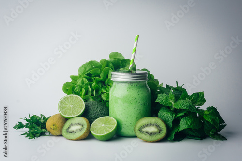 Green detox healthy smoothie from green fruit - avocado  salad  kale  lime  kiwi  mint. Alkaline diet concept. Vegan healthy alkaline food. Green fruit background. Flat lay. Copy space.