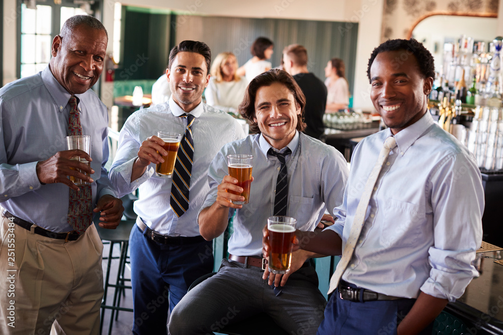 Portrait Of Businessmen Meeting For After Works Drinks In Bar Portrait Of Businessmen Meeting For After Works Drinks In Bar