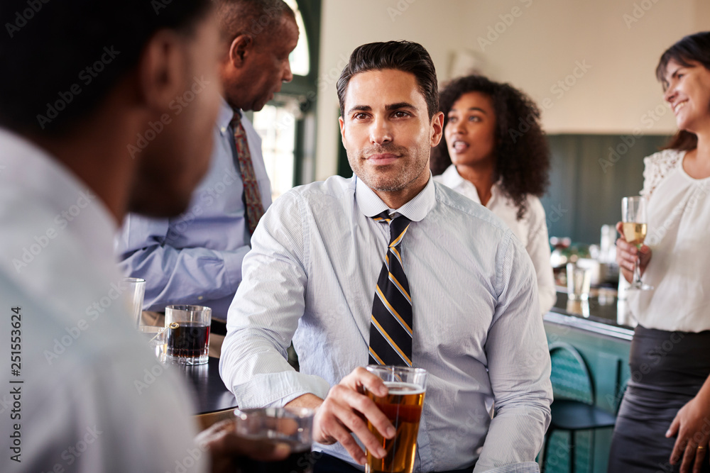 Two Businessmen Meeting For After Works Drinks In Bar Two Businessmen Meeting For After Works Drinks In Bar