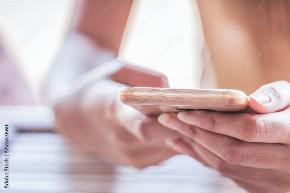 Fototapeta premium In the hands of women are mobile phones.