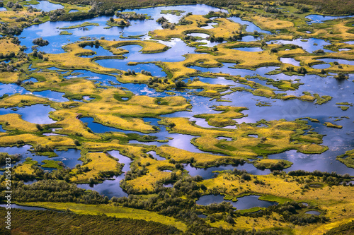 Top view of the oxbow lake and many small islands. Aerial photography. Picturesque summer tundra. Amazing landscapes of the Arctic. Chukotka, Siberia, Far East of Russia.