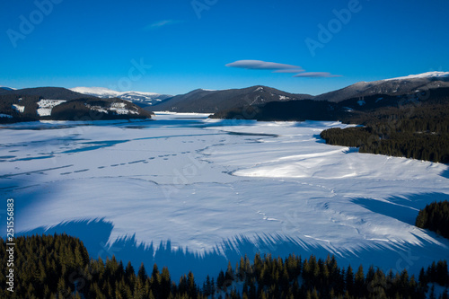 beautiful scenery with a mountain lake during winter seen from above