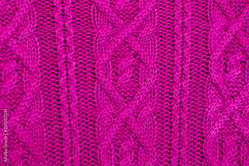 Knit texture of pink wool knitted fabric with cable pattern as background. Magenta texture. Knit texture of pink wool knitted fabric with cable pattern as background. Magenta texture.