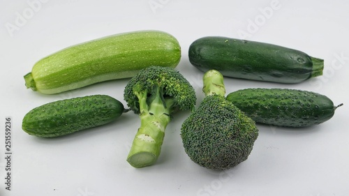Vegetables and fruits of green color on the white background. Healthy food.