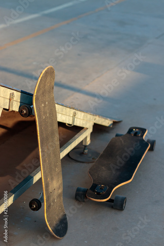 sakteboard and longboard at a skatepark photo