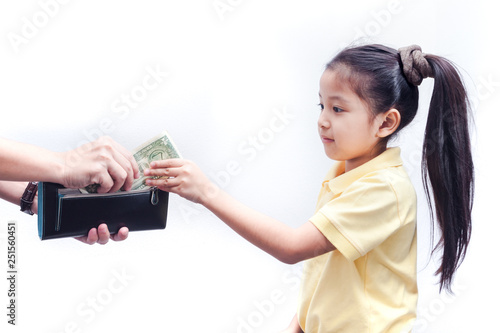 Young girl receive american bank note from parent.