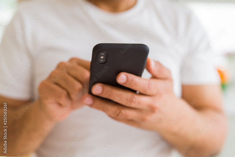 Close up of middle age man hands using smartphone at home Close up of middle age man hands using smartphone at home