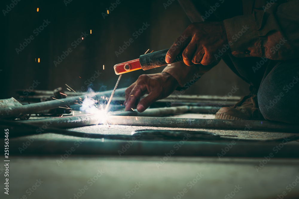 Flame sparks are caused by welding. Stock Photo Adobe Stock