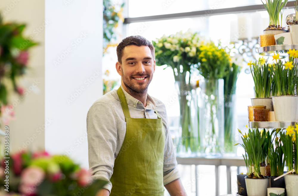 sale, small business and floristry concept - happy smiling florist man or seller at flower shop sale, small business and floristry concept - happy smiling florist man or seller at flower shop