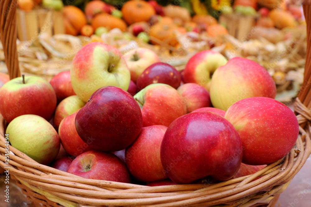 Red apples in the wooden basket at the market. Fruit and business concept. Red apples in the wooden basket at the market. Fruit and business concept.
