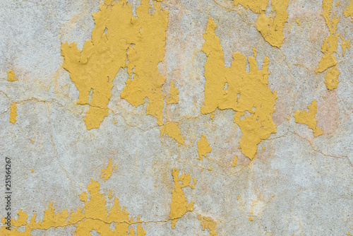 old peeling yellow painted wall texture background