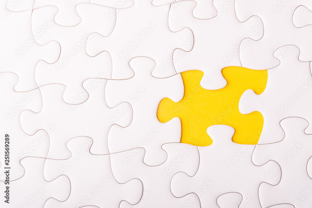 White jigsaw puzzle and missing pieces with selective focus and crop fragment White jigsaw puzzle and missing pieces with selective focus and crop fragment