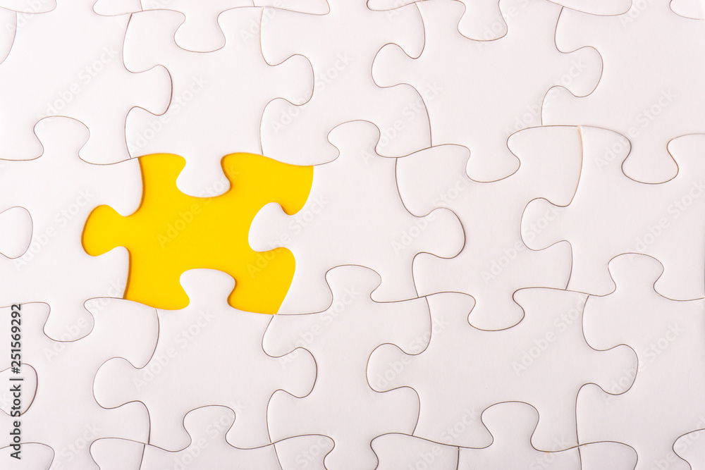 White jigsaw puzzle and missing pieces with selective focus and crop fragment White jigsaw puzzle and missing pieces with selective focus and crop fragment