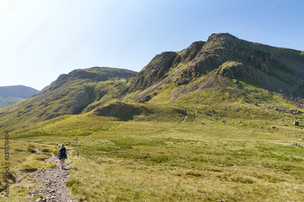 Female hiker backpacking with views of Kirk Fell In the English Lake District, UK.