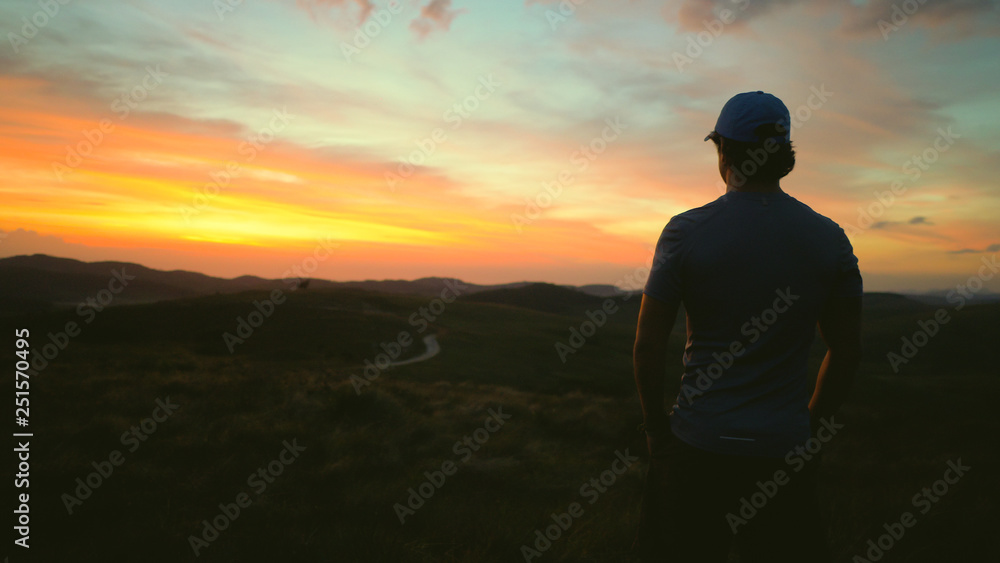 Man watching the sunrise in the mountains