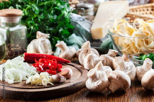 Ingredients ready for prepare tagliatelle pasta with champignon