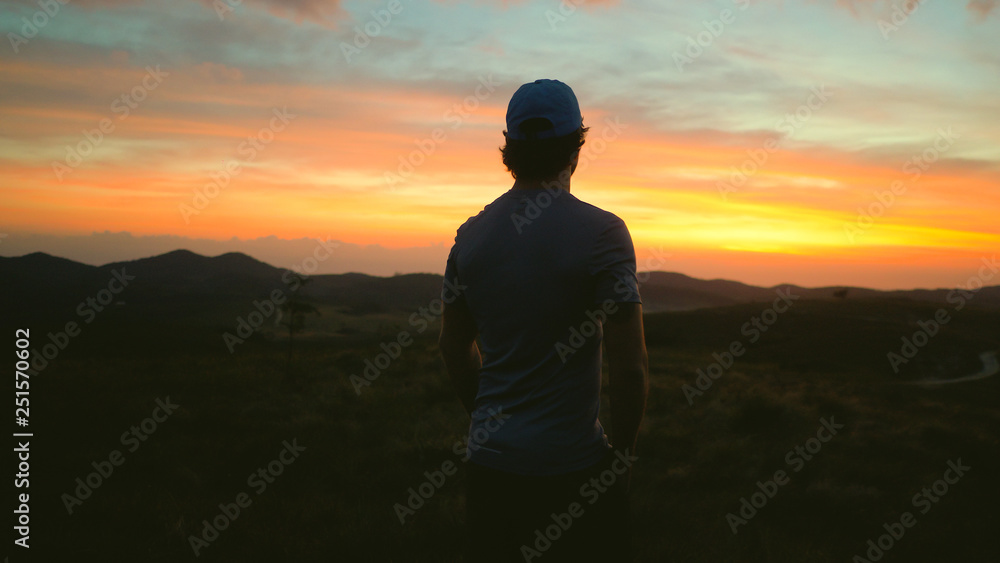 Man watching the sunrise in the mountains Man watching the sunrise in the mountains