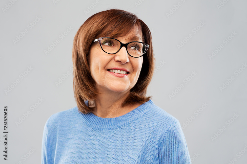 vision and old people concept - portrait of smiling senior woman in glasses over grey background vision and old people concept - portrait of smiling senior woman in glasses over grey background