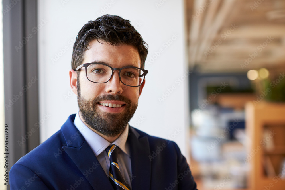 Fototapeta premium Portrait Of Businessman In Modern Office Standing By Window