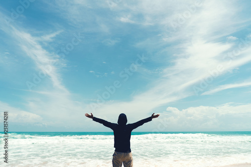 Copy space of man rise hand up on blue sky at beach and island background.