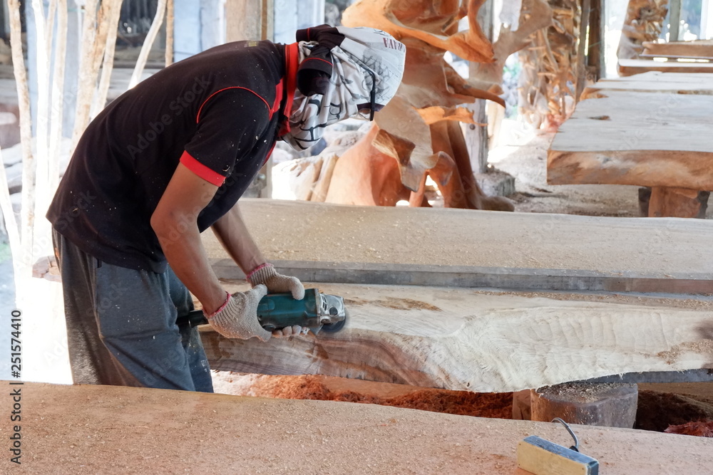 people's activities are smoothing wood with a machine people's activities are smoothing wood with a machine