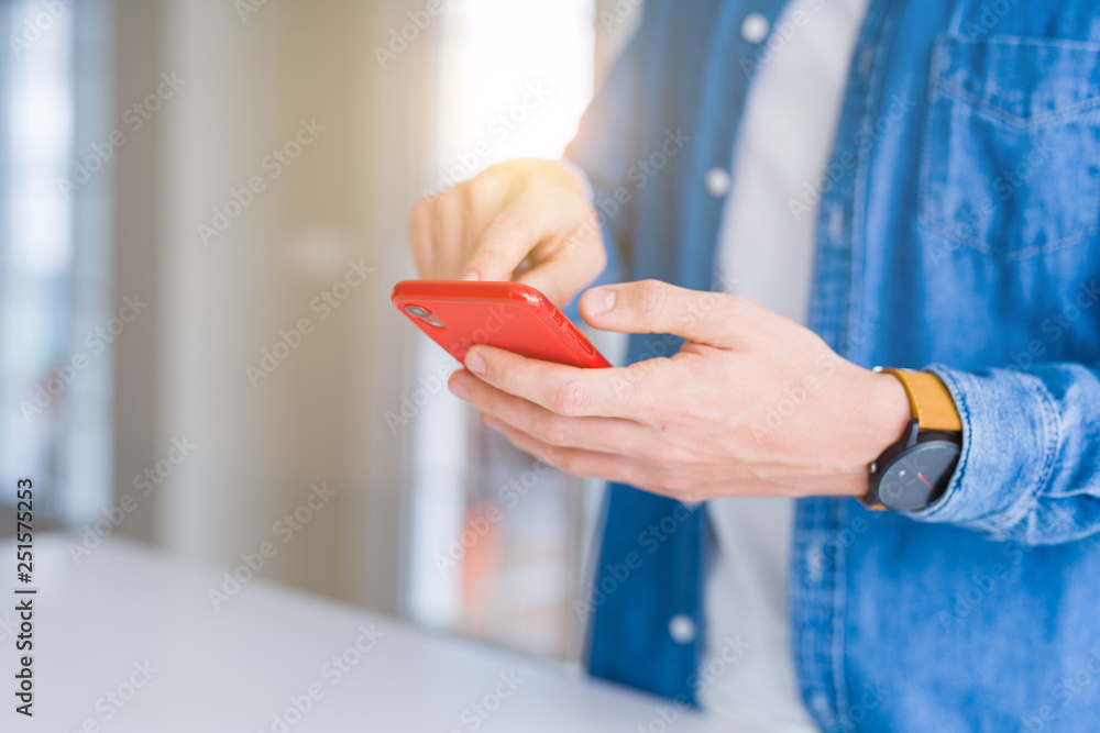 Close up of man hands using smartphone and smiling Close up of man hands using smartphone and smiling