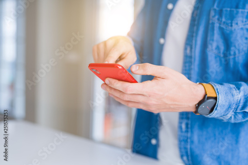 Close up of man hands using smartphone and smiling