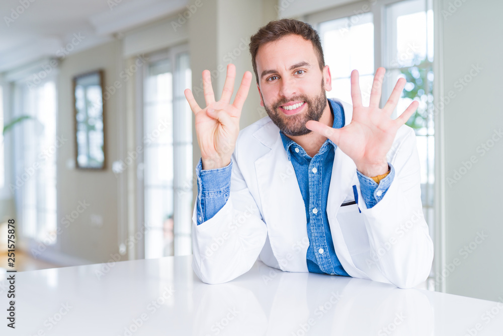 Handsome doctor man wearing medical coat at the clinic showing and pointing up with fingers number nine while smiling confident and happy. Handsome doctor man wearing medical coat at the clinic showing and pointing up with fingers number nine while smiling confident and happy.
