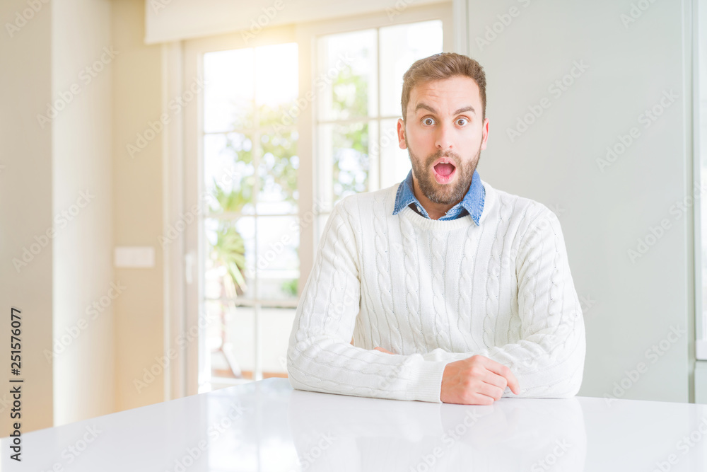 Handsome man wearing casual sweater afraid and shocked with surprise expression, fear and excited face. Handsome man wearing casual sweater afraid and shocked with surprise expression, fear and excited face.