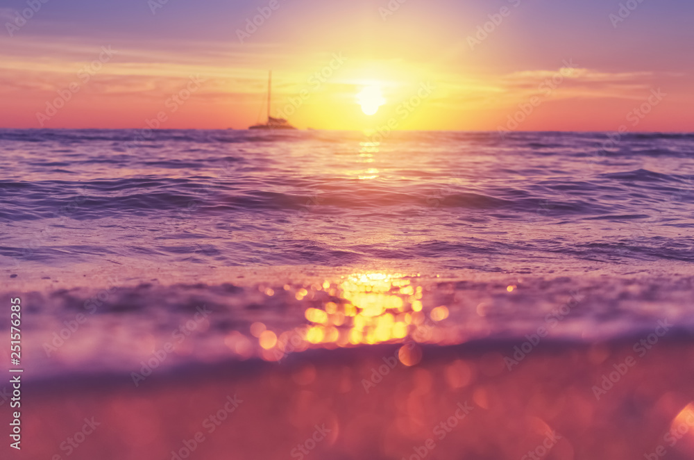 Blur tropical sunset beach with bokeh sun light wave abstract background. Blur tropical sunset beach with bokeh sun light wave abstract background.