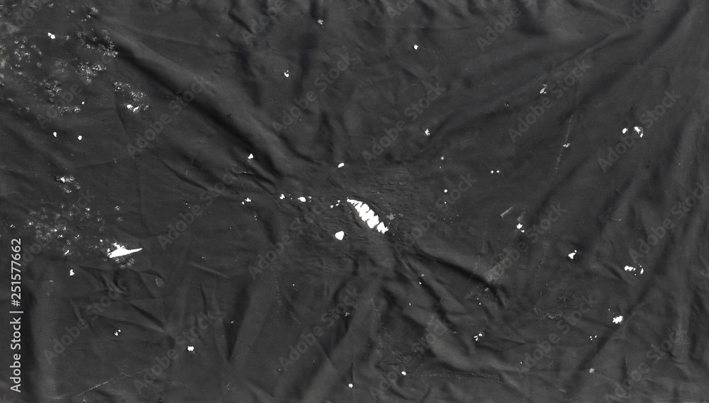 Fototapeta premium black abstract background of old torn fabric